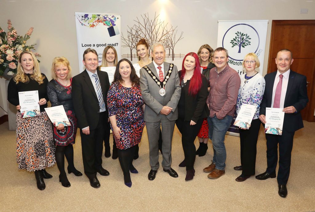 12 Northern Ireland bloggers received certificates for completing a six-week course at Lisburn City Library. Delivered by TrainingMatchmaker.com and backed by Libraries NI the course introduced new and intermediate bloggers to the tools and techniques necessary to become a successful presence in the online world. Mayor of Lisburn and Castlereagh City Council, Councillor Uel Mackin, presented certificates to all participants at Civic Headquarters, Lagan Valley Island, Lisburn on December 20. . Pictured Front row: Fiona Taylor (participant), Lynda Willis (participant), Jim O'Hagan (CEO Libraries NI), Christine Watson Chartered Marketer at Watson and Co Chartered Marketing (founder of TrainingMatchmaker.com), Councillor Uel Mackin (Mayor of Lisburn & Castlereagh City Council), Tina Calder (TrainingMatchmaker.com trainer Excalibur Press), Ciaran Connolly (TrainingMatchmaker.com trainer Profile Tree), Mary Jane Burns (participant) and David Archer (participant). Back row: Karen McIlwee (participant), Clare Flynn (participant) and Jill McDowell (participant).